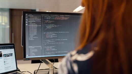 female software engineer coding on computer
